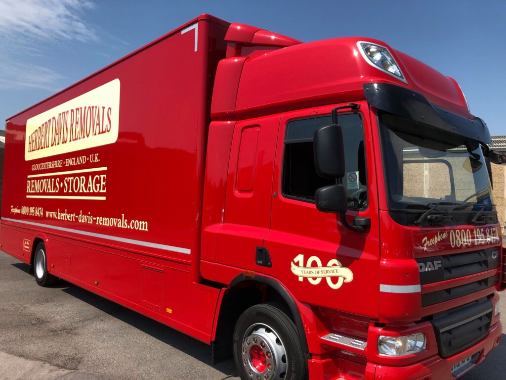 Red Herbert Davis Removals lorry with its 100 years of service badge